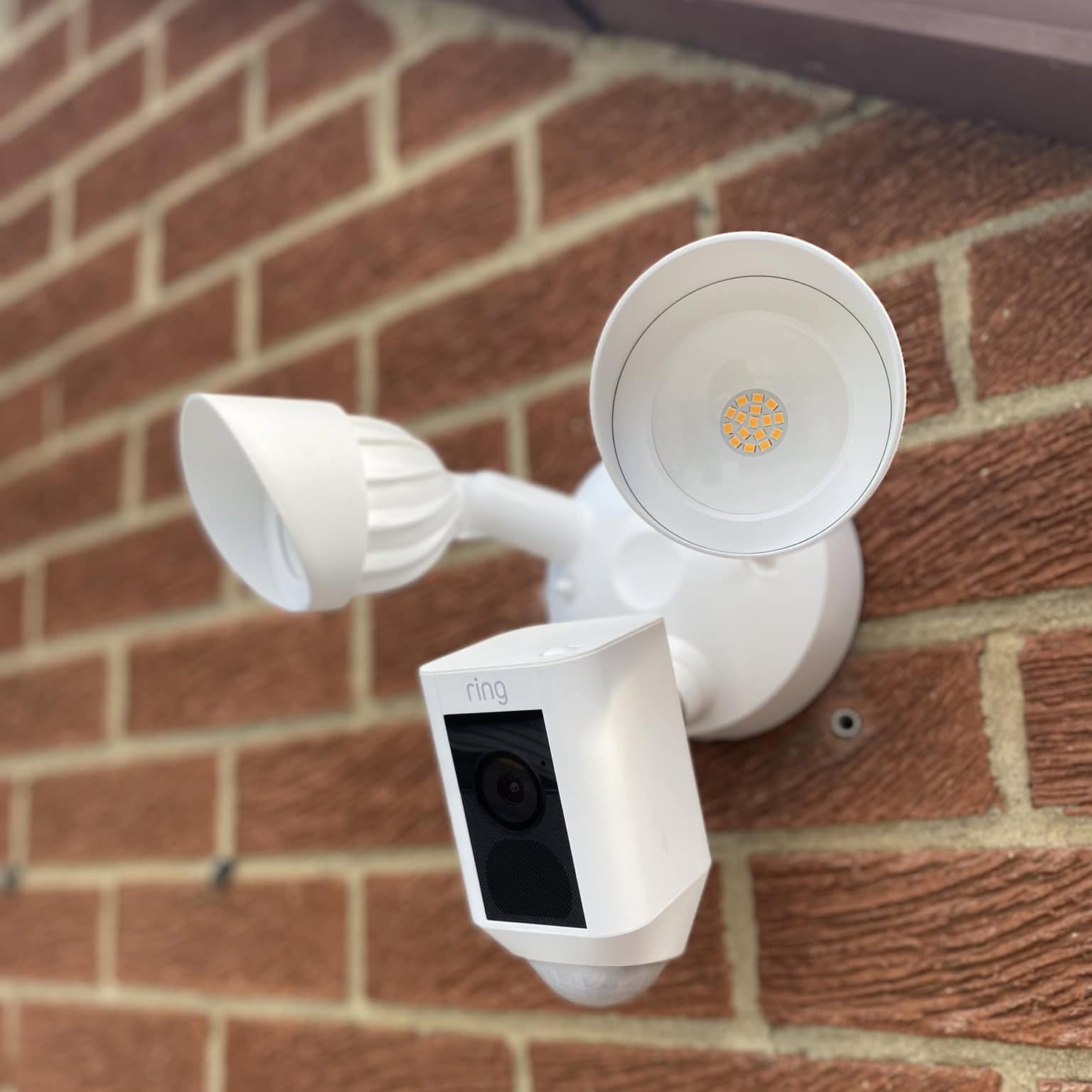 Floodlight camera on an exterior wall