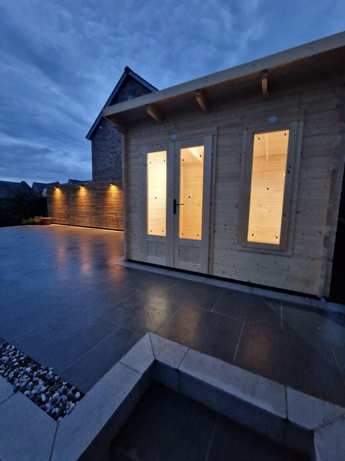 Garden room and fence downlights at blue hour