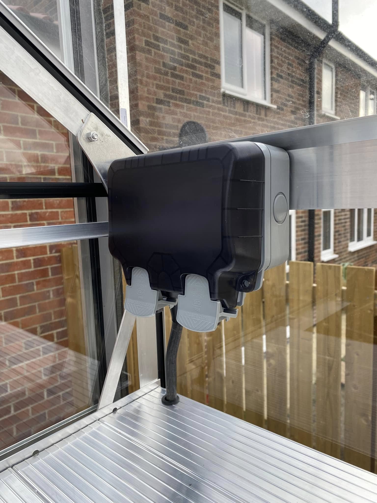 Weatherproof socket on a greenhouse frame